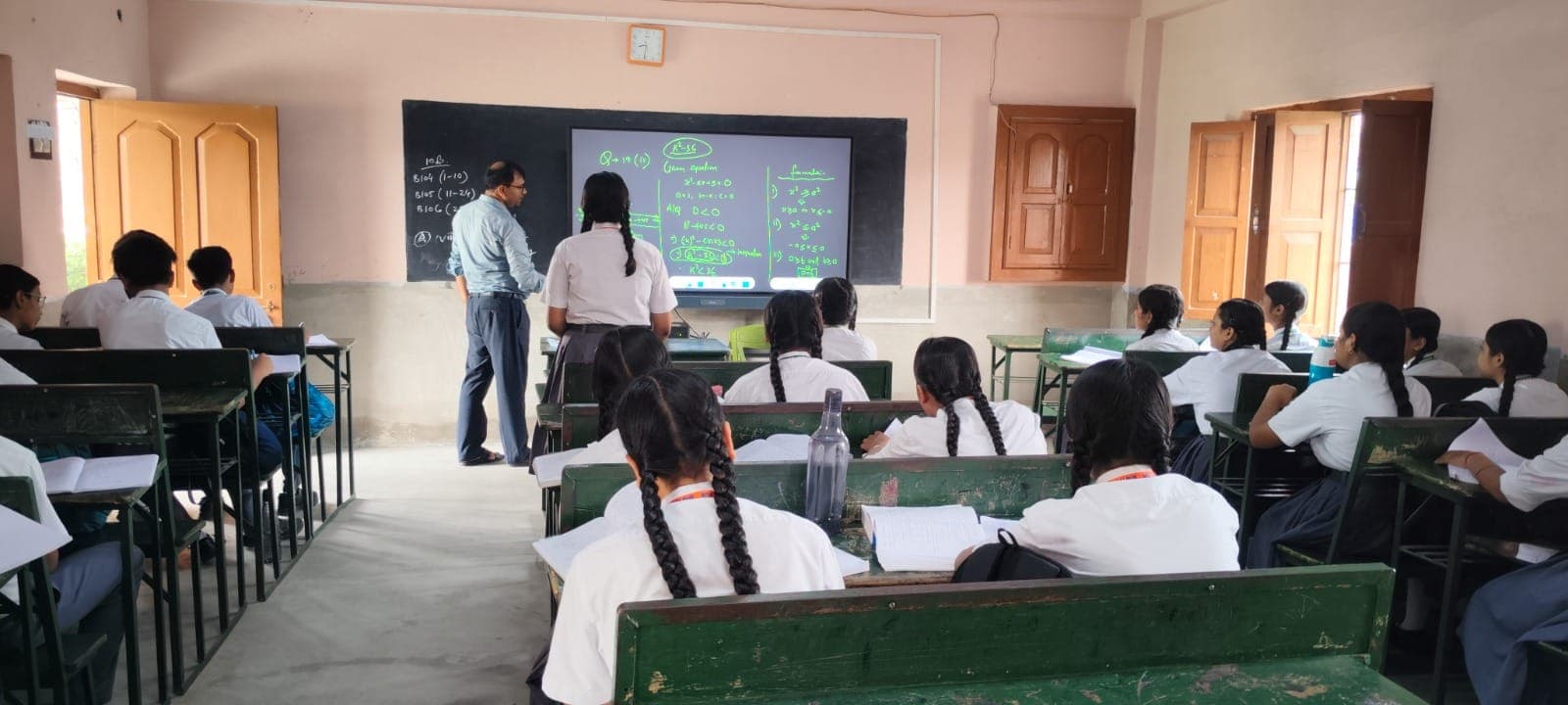 Teacher at smartboard in a senior classroom